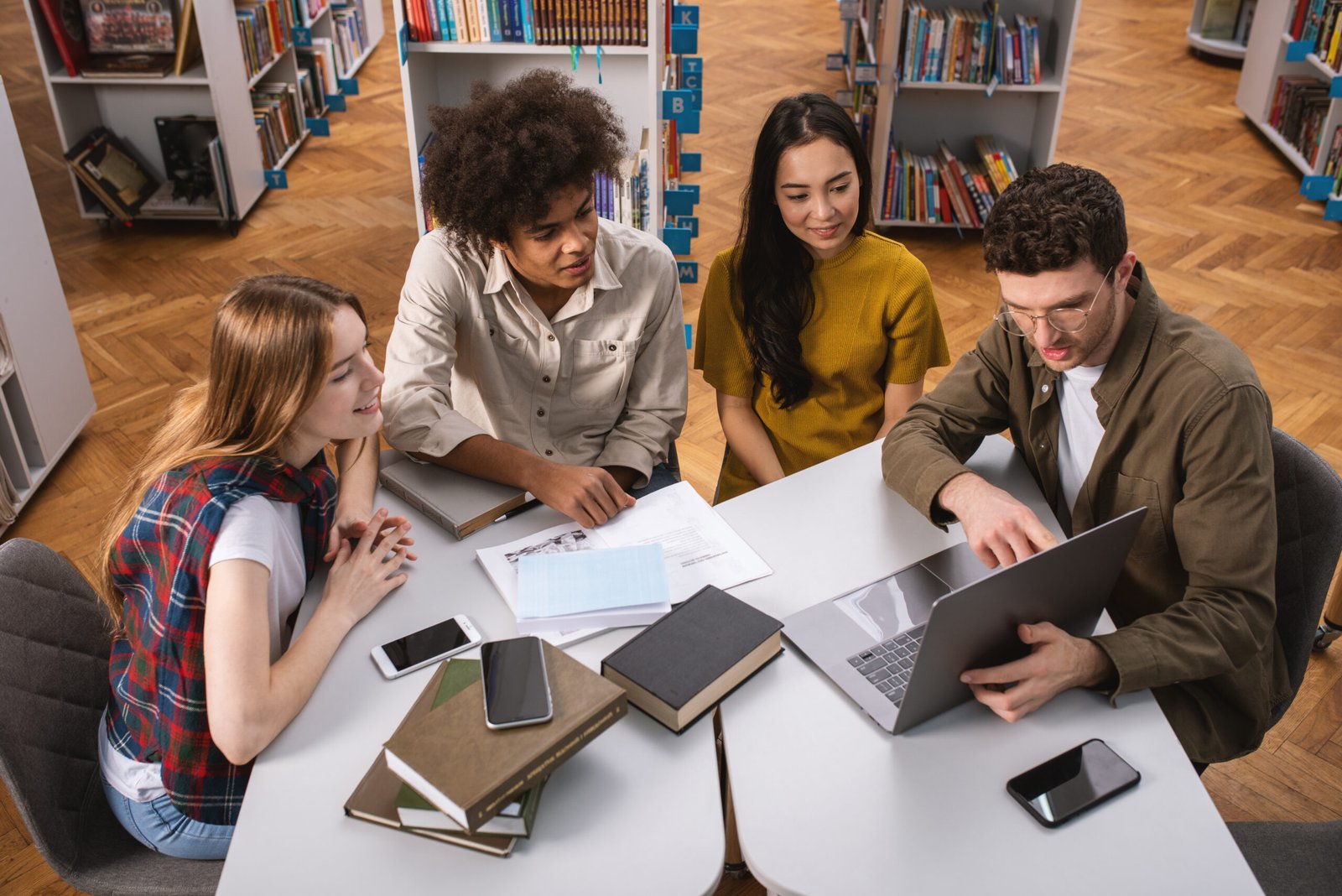 university students are studying in a library together. concept of teamwork and preparation