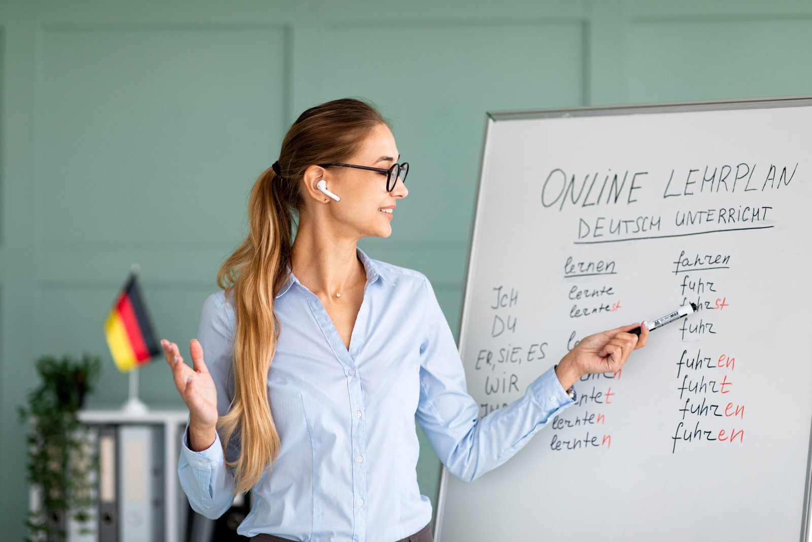 happy german teacher explaining foreign language rules, wearing airpods, teaching linguistic online course